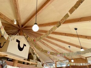 中から見た天井。中央から壁へ向けて、たくさんの「ひみつジャナイカード」が吊るされている。